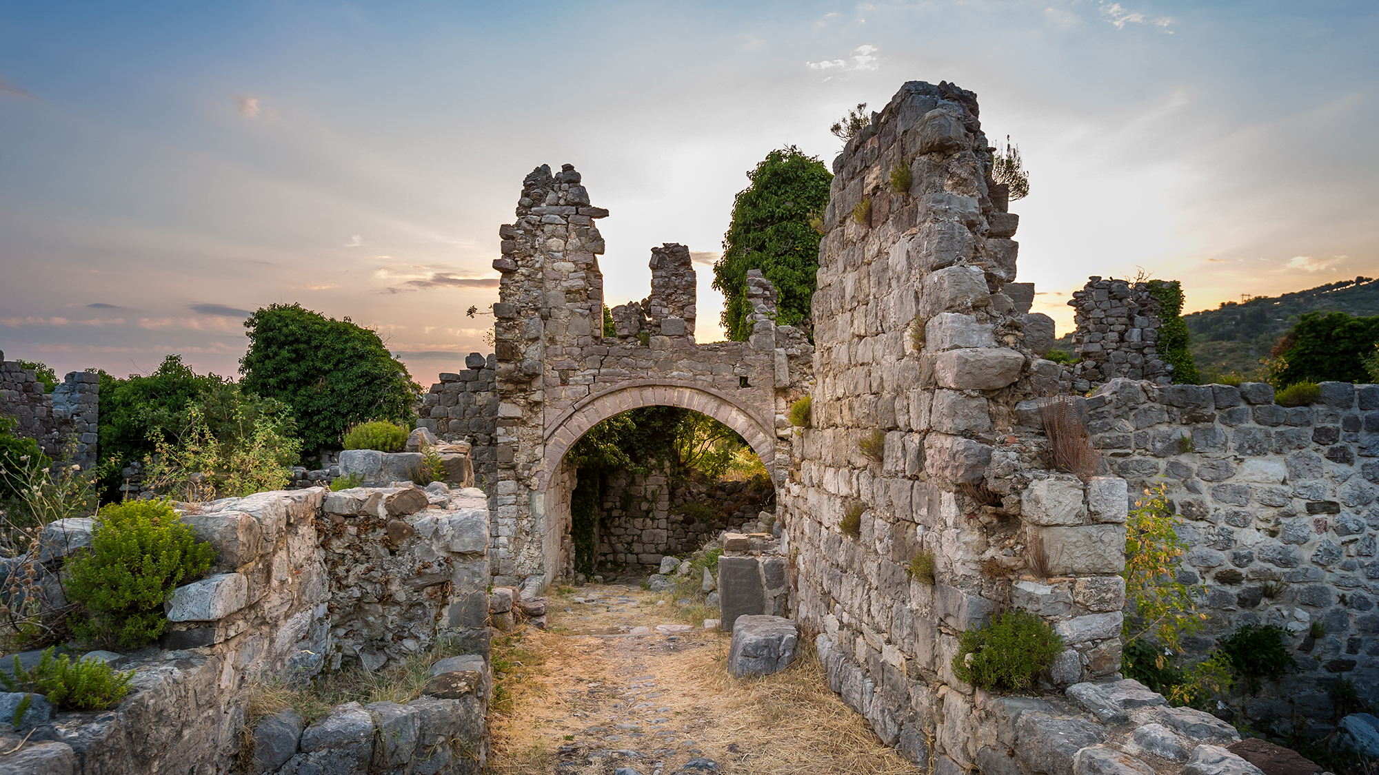 Ruins of Stari Bar ancient fortress, arch way to ruined defense tower, Montenegro.