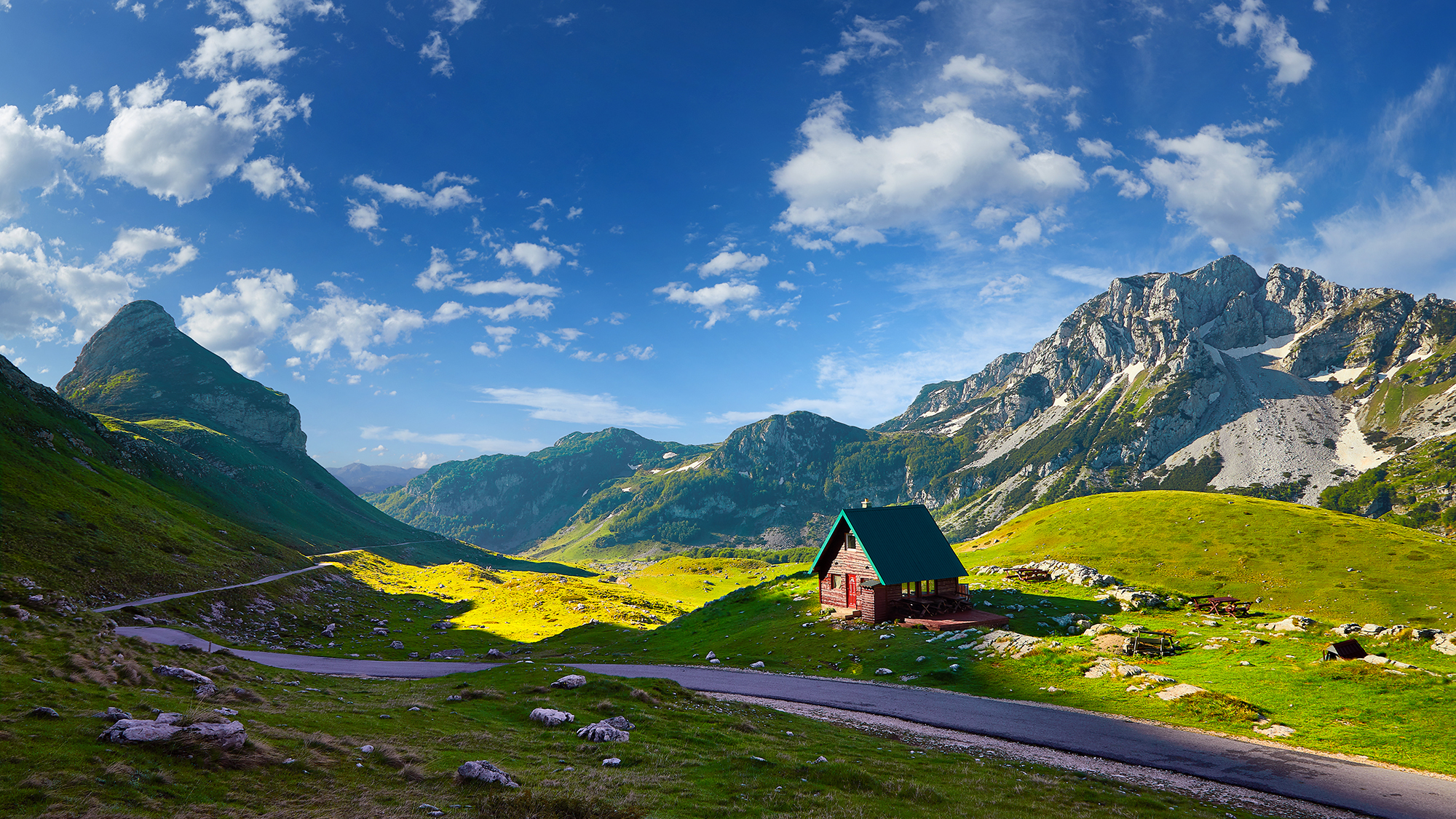 Amaizing sunset view on Durmitor mountains, National Park, Mediterranean, Montenegro, Balkans, Europe.  Bright summer view from Sedlo pass. Instagram picture. The road near the house in the mountains.